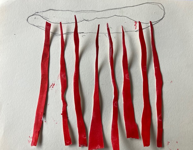 maakproces: vel papier met rode stukjes papier met daarboven een wolk getekend met potlood